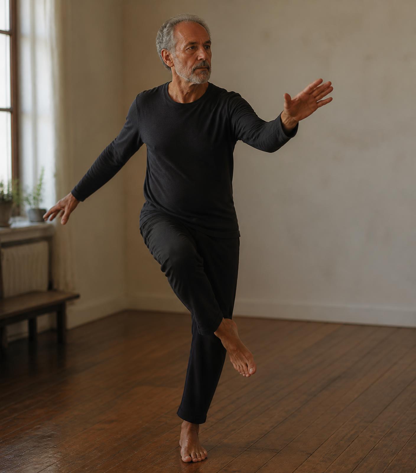 Christopher Gladwell balancing on one leg in a bright, simple room